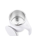 White magnetic stirring mug tilted to show the stainless steel inner liner